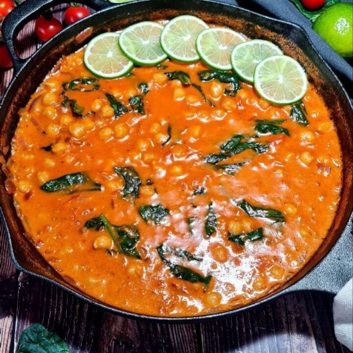 Rich and creamy vegan coconut chickpea curry served with fluffy rice and fresh herbs