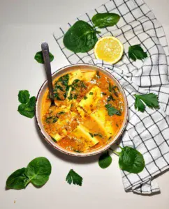 Bowl of lasagna soup with spinach, lemon, and parsley