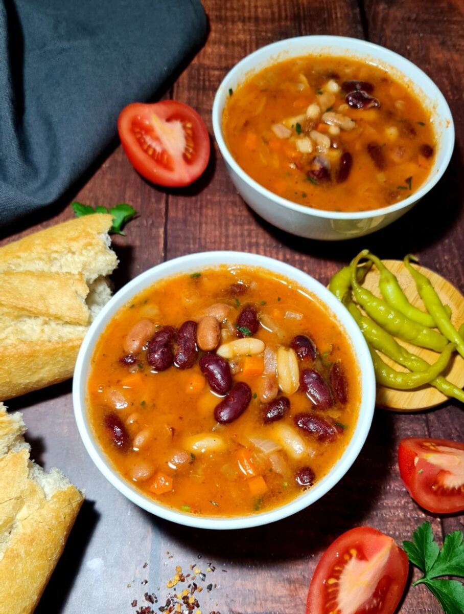 Bowl of hearty three bean soup filled with kidney beans, pinto beans, tomatoes, and savory spices, perfect for cold days.