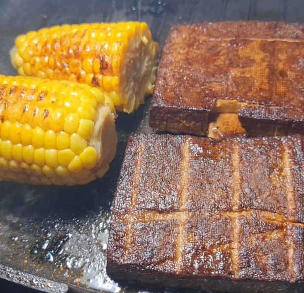 corn cobs of corn on a grill