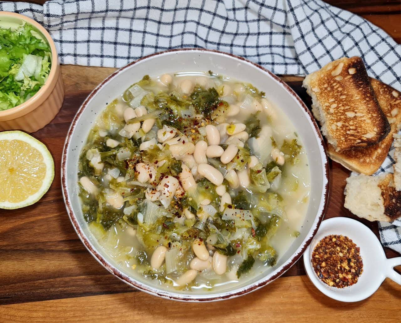 a bowl of soup with beans and vegetables