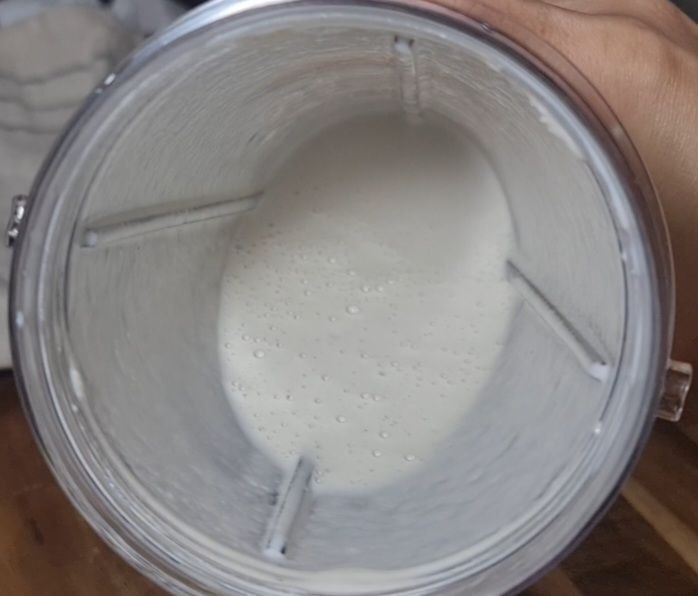 a glass container with a white liquid inside - cashew cream for soup