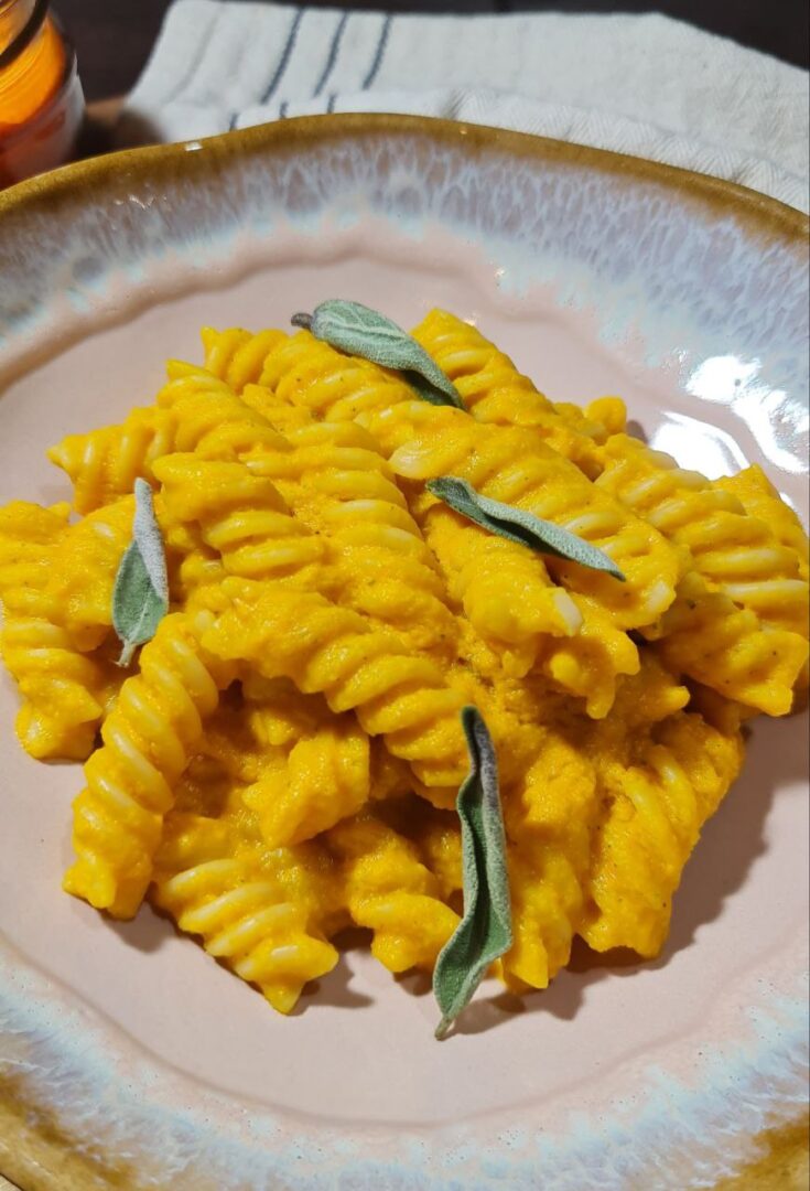 a plate of creamy vegan pumpkin pasta with sauce