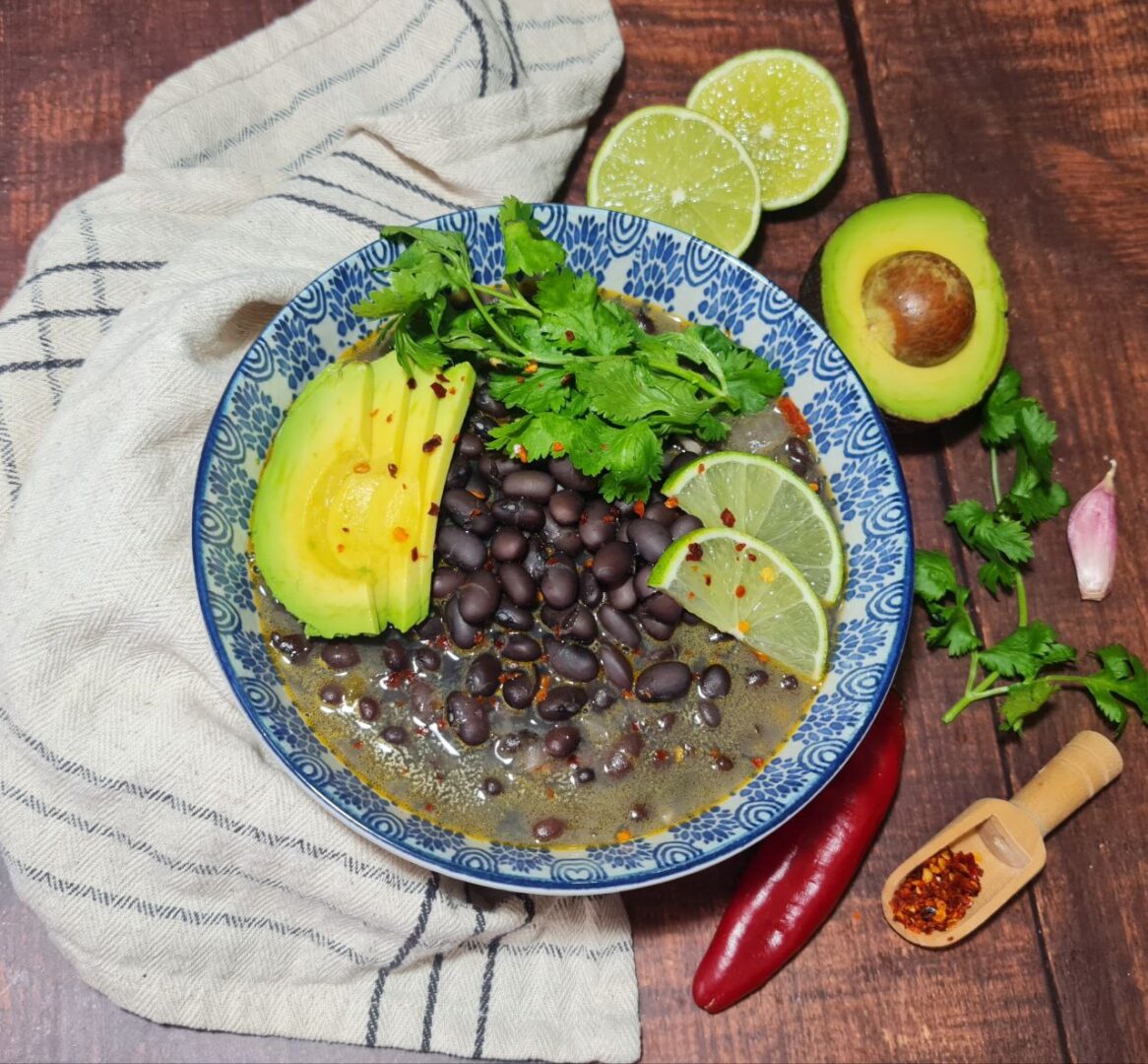 a bowl of food with avocado and beans