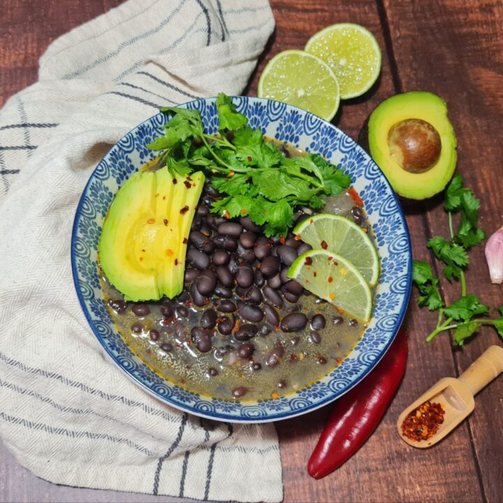 a bowl of food with avocado and beans