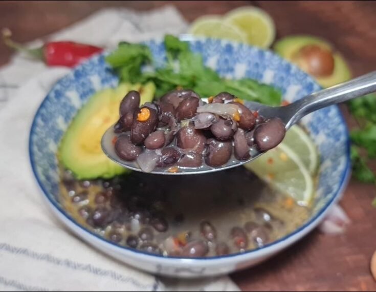 spicy black bean soup with lime spoon