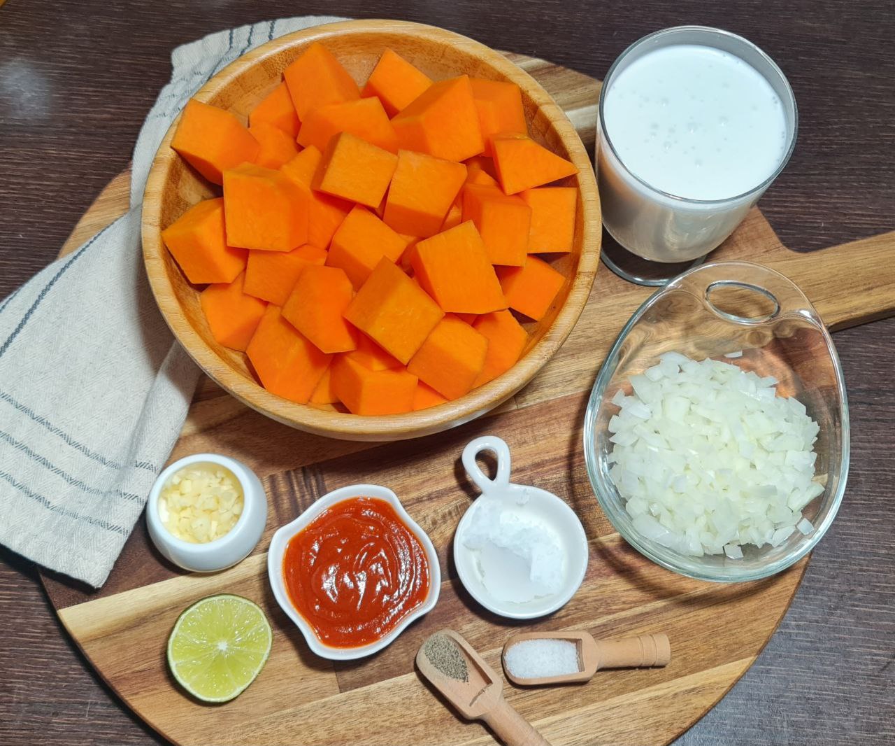 a bowl of food with ingredients on a wooden board