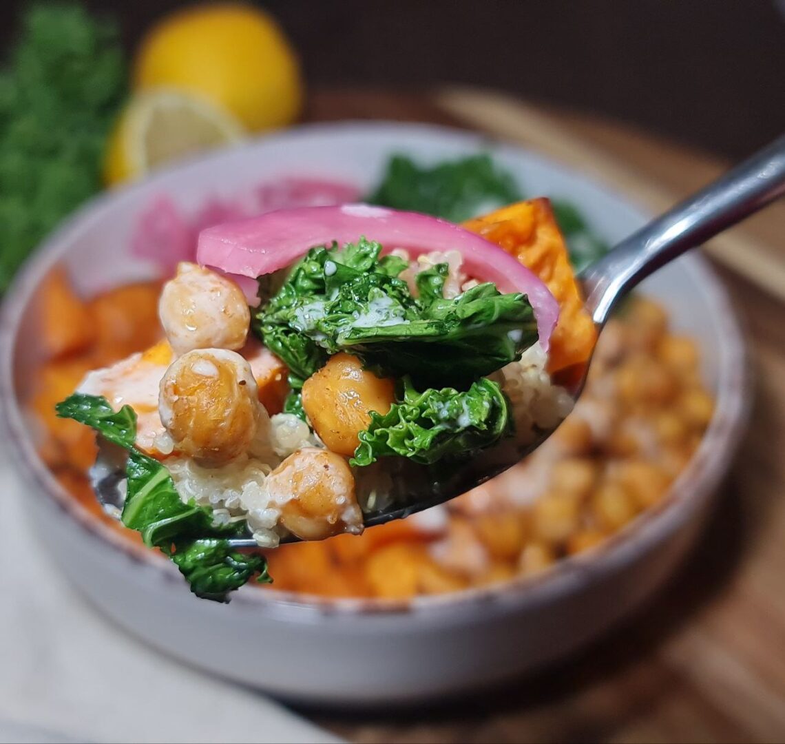  Spoonful of vegan quinoa bowl with kale, chickpeas, pickled onions, and sweet potatoes.  A spoonful of deliciousness from the vegan quinoa bowl with roasted sweet potatoes, chickpeas, and kale.