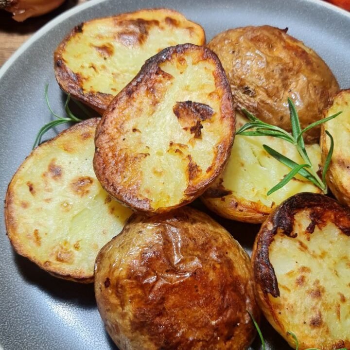 Served halved roasted potatoes with herbs.