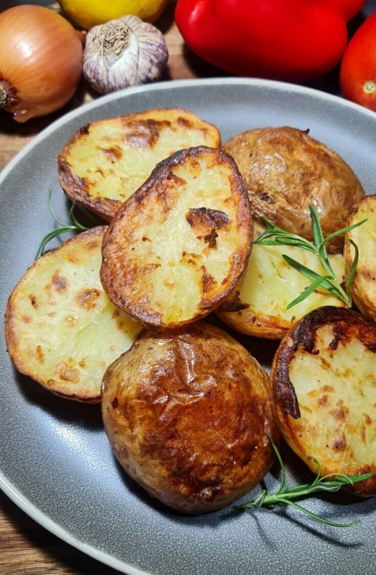 halved roasted potatoes served on plate