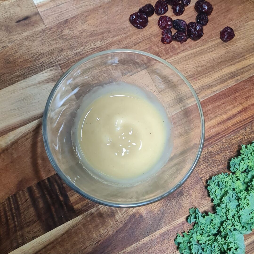 Smooth lemon tahini dressing in a glass bowl.
Silky smooth lemon tahini dressing, the perfect accompaniment for a simple kale salad.