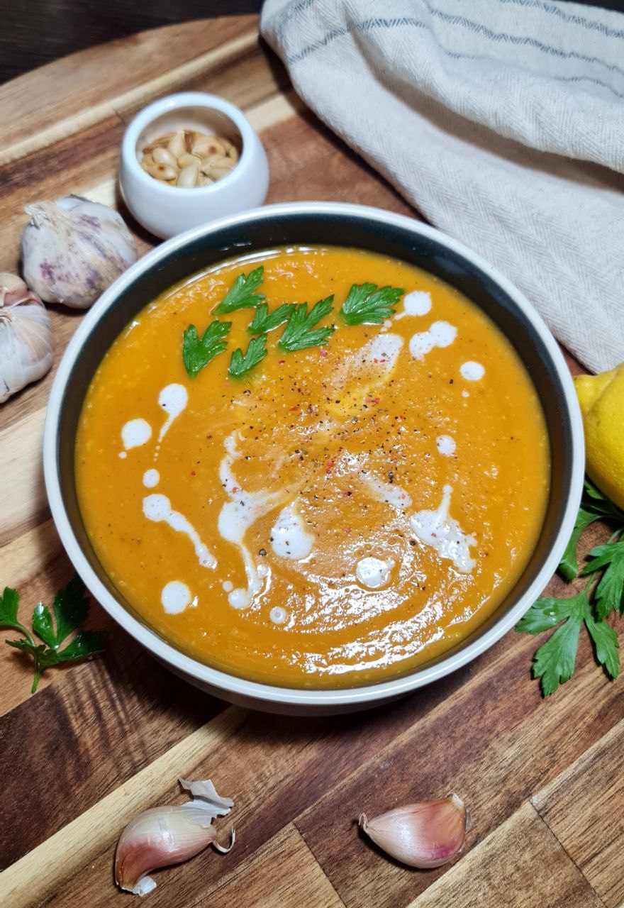 a bowl of soup with parsley and garlic