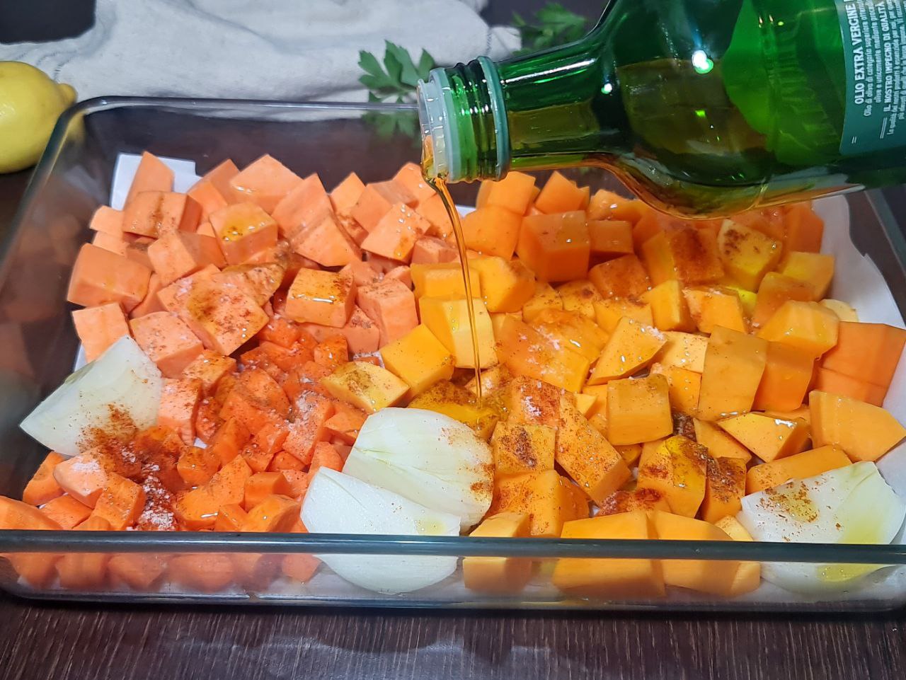 Cubed butternut squash, sweet potato, carrots, and onion drizzled with olive oil and spices before roasting. Butternut squash, sweet potatoes, carrots, and onion ready for roasting with olive oil and spices.