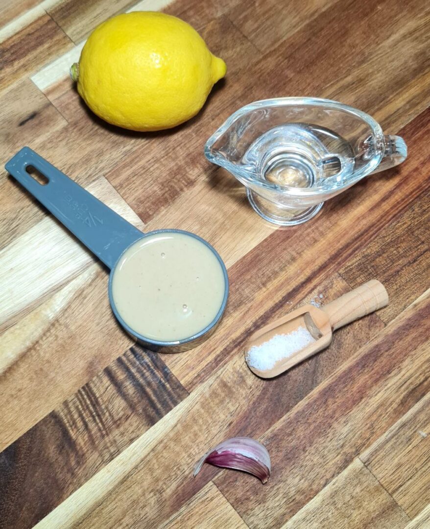 Ingredients for tahini dressing: tahini, lemon, garlic, water, and salt. The essential ingredients for making homemade tahini dressing.