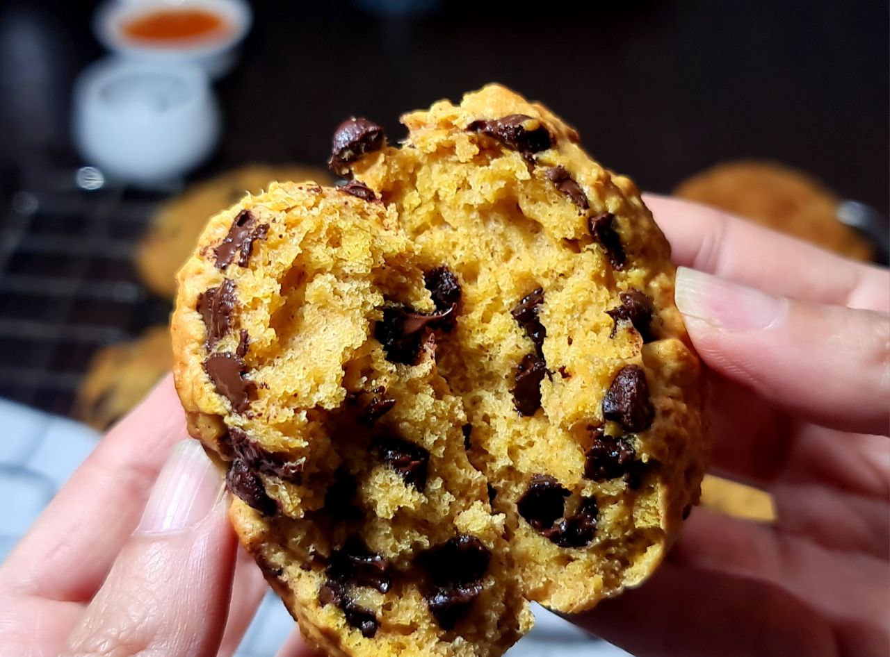 a hand holding a cookie