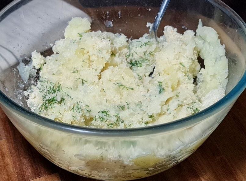 a bowl of mashed potatoes with a spoon