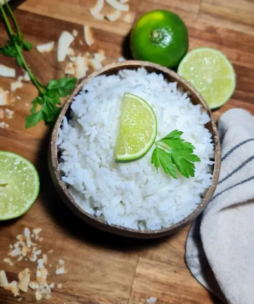 A bowl of creamy coconut rice served as a delicious side dish garnished with fresh cilantro.