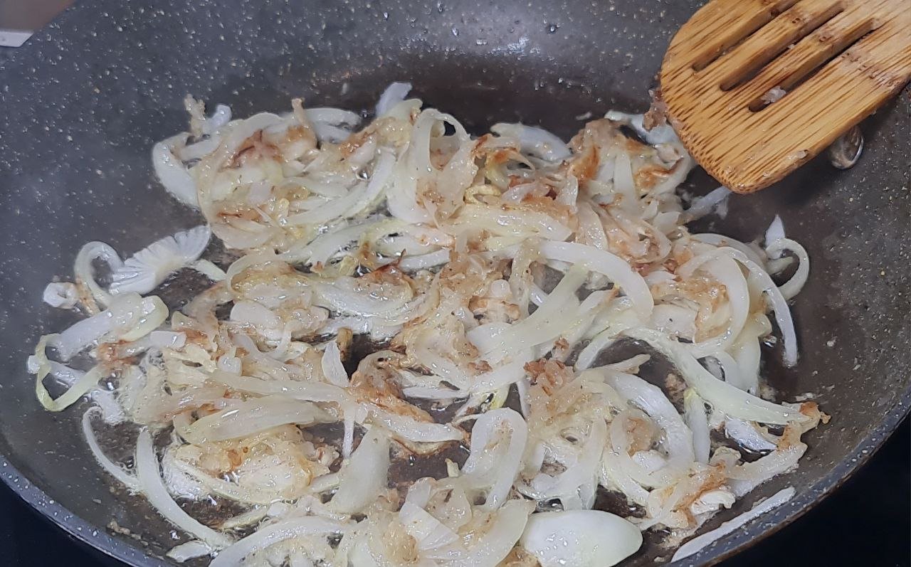 onions cooking in a pan