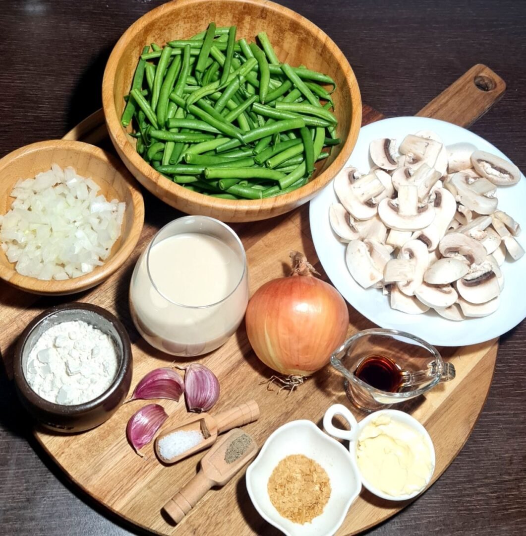 Ingredients for vegan green bean casserole, including green beans, mushrooms, onions, and seasoning. Fresh ingredients ready for making a delicious vegan green bean casserole.