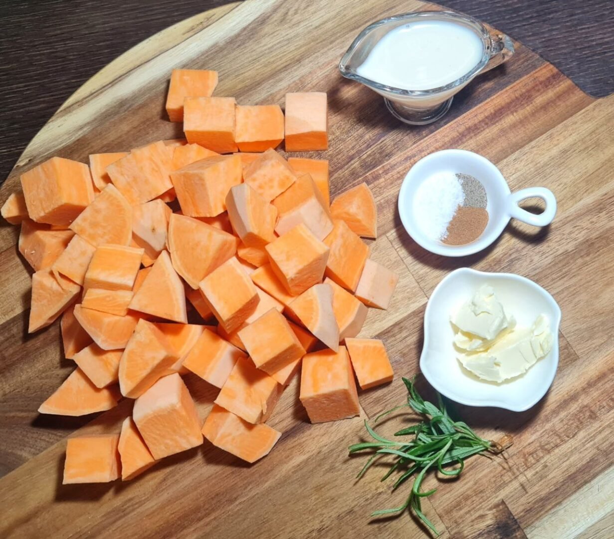 Raw ingredients for vegan mashed sweet potatoes, including sweet potato cubes, vegan butter, spices, and rosemary.
Fresh ingredients for vegan mashed sweet potatoes, ready to cook.