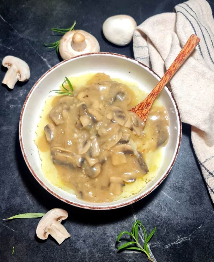 a bowl of food with a wooden spoon