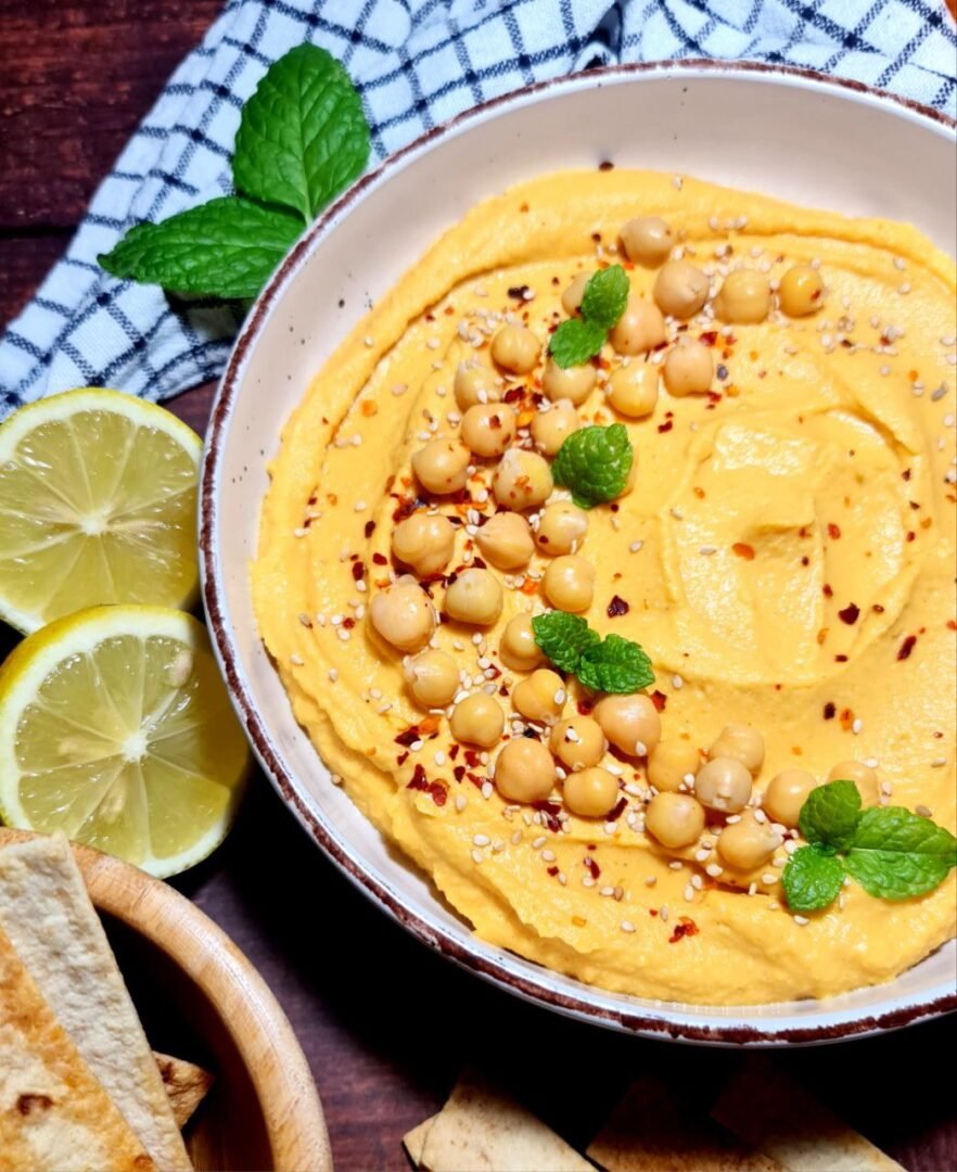 a bowl of hummus with spices and herbs