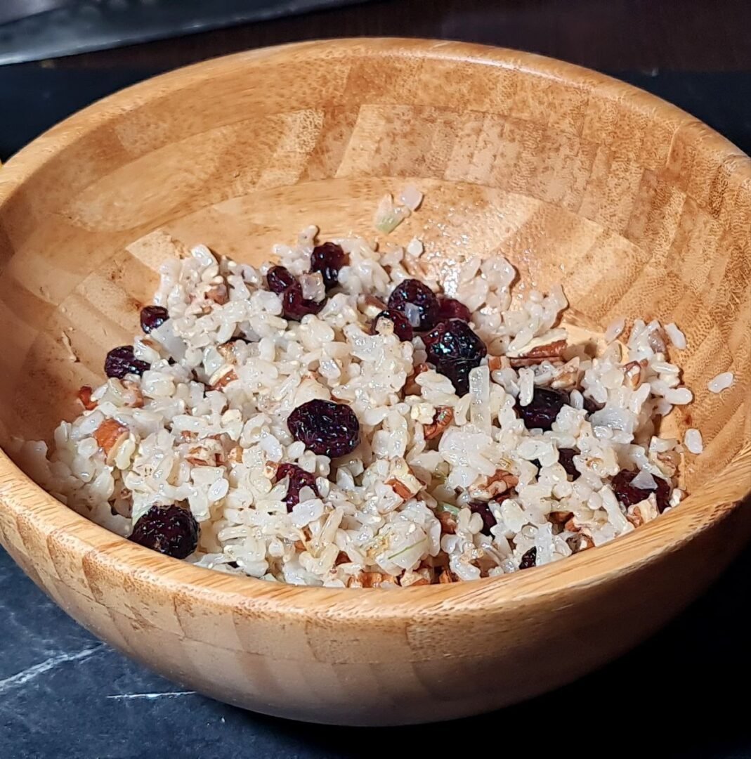 a bowl of rice with raisins and nuts