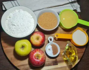 Fresh ingredients for vegan apple cake including apples, flour, sugar, and plant-based milk. Fresh and wholesome ingredients for a delightful vegan apple cake.