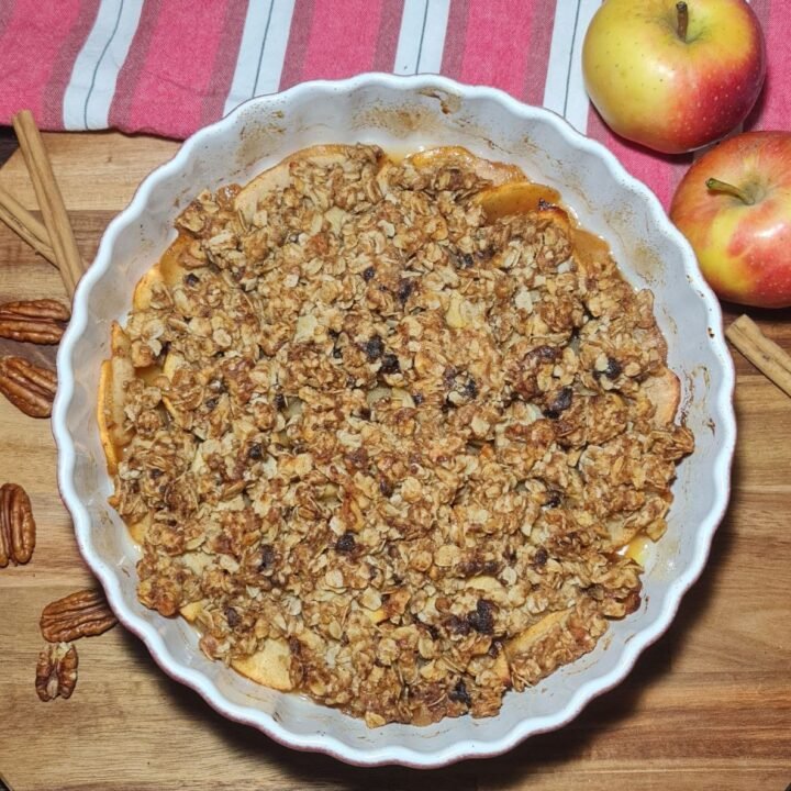 Bowl of warm vegan apple crisp. Warm vegan apple crisp.