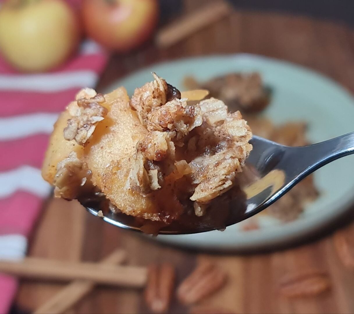 Close-up of vegan apple crisp showing the crispy oat topping and tender baked apples. Close-up of vegan apple crisp with a crunchy oat topping and tender baked apples.