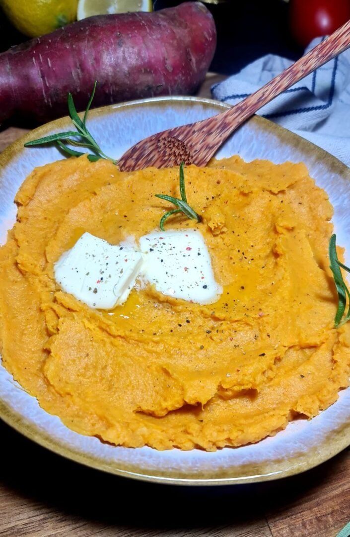 a bowl of mashed potatoes with vegan butter and rosemary