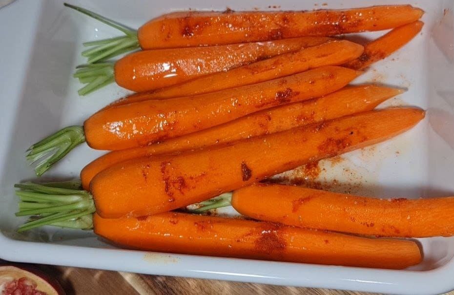 a group of carrots in a white dish