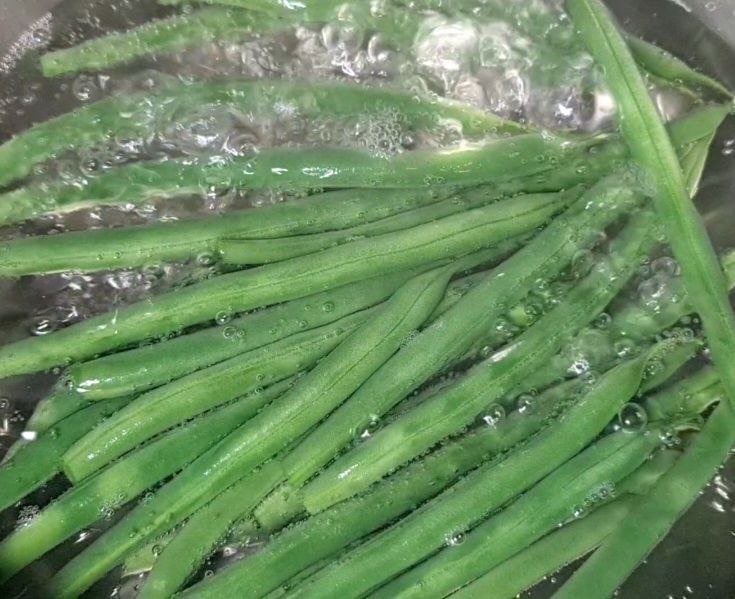 Fresh green beans boiling in water.