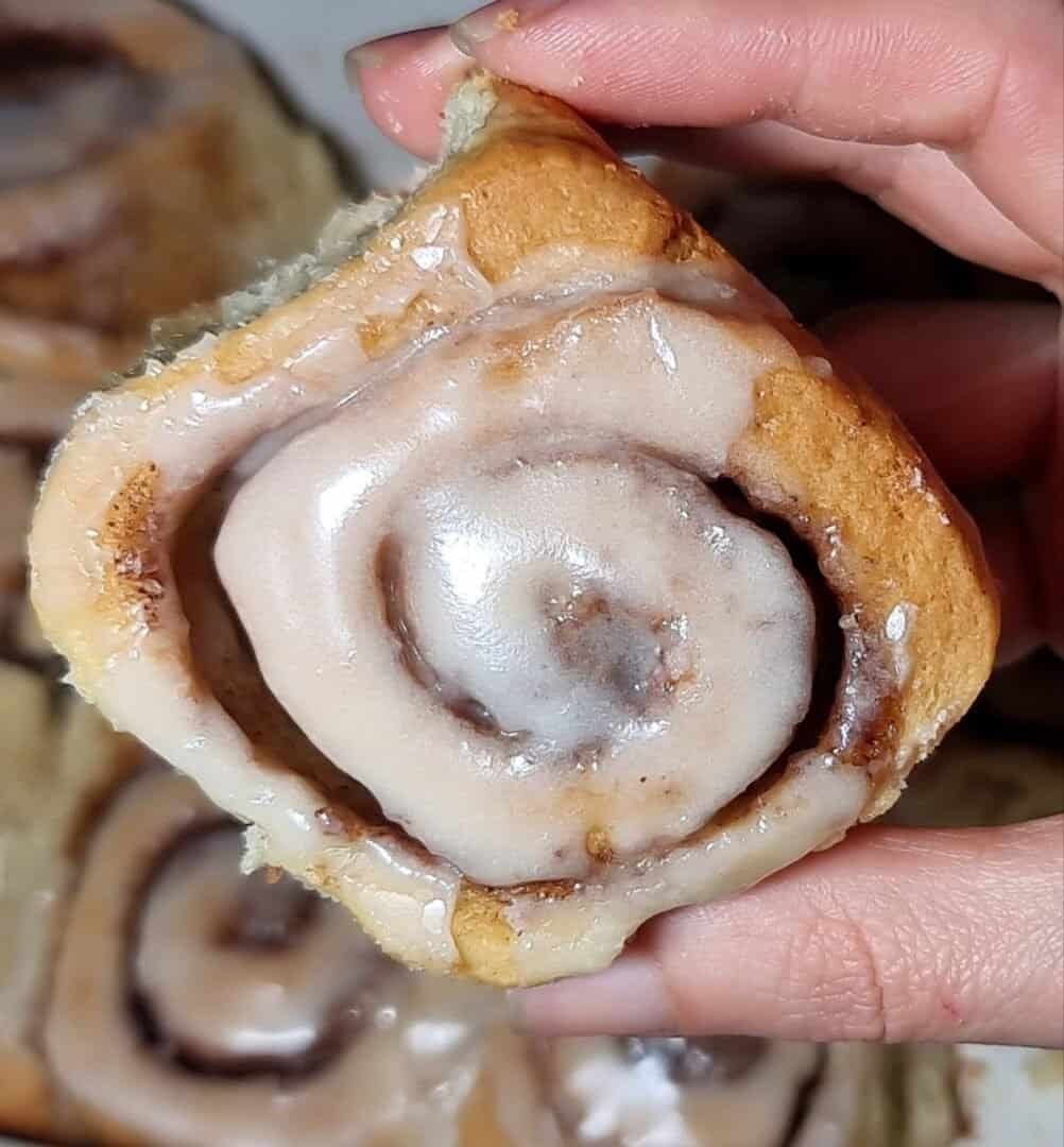 Close-up of a vegan cinnamon roll with icing