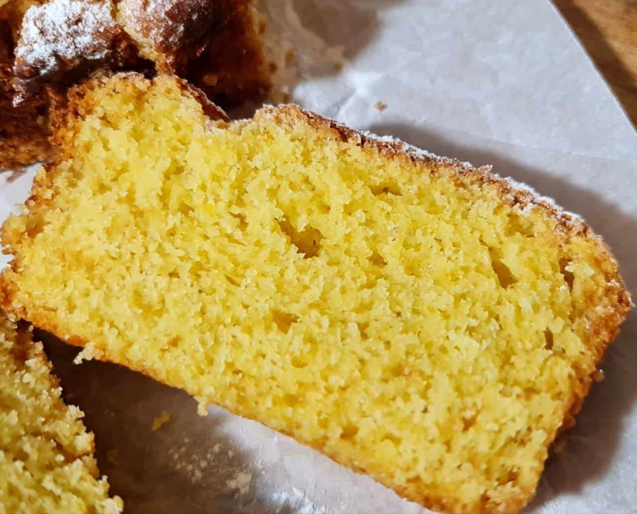 lose-up of a slice of vegan orange cake with a moist and fluffy texture.