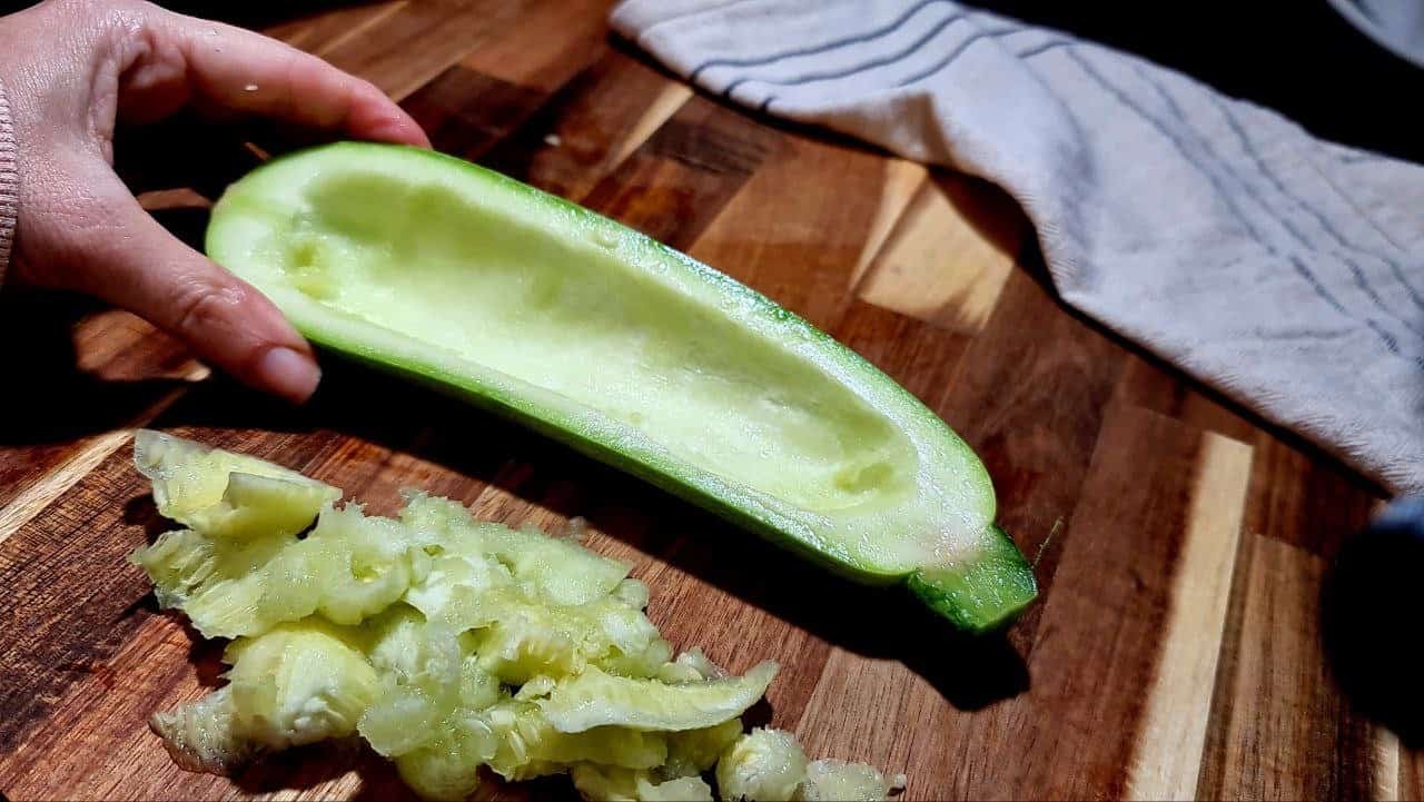 a hand holding a vegetable cut into a half