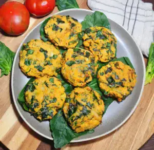 Close‑up of a single Vegan Chickpea Spinach Patty showing its soft, herb-speckled texture.