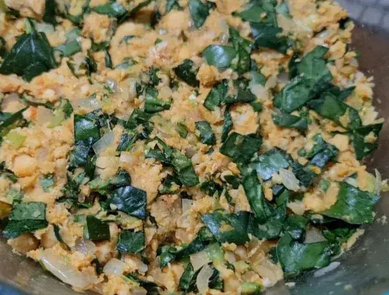 Close‑up of the chickpea and spinach mixture with visible herbs and onions before shaping into Vegan Chickpea Spinach Patties.