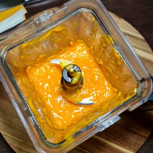 Blended carrot soup in a food processor with smooth texture