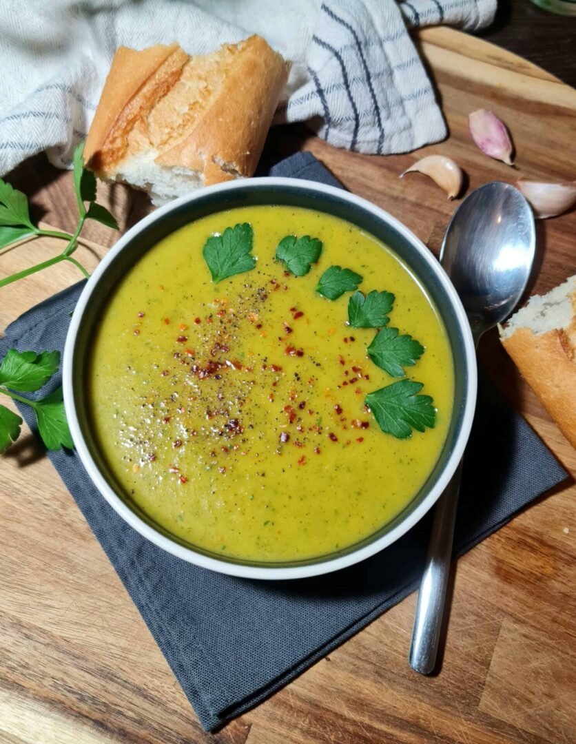 leeks and carrots sautéing in a pot for creamy zucchini soup
